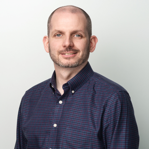 An image of Graham Dyer wearing a blue shirt and smiling at the camera. An image of Graham Dyer wearing a blue shirt and smiling at the camera.