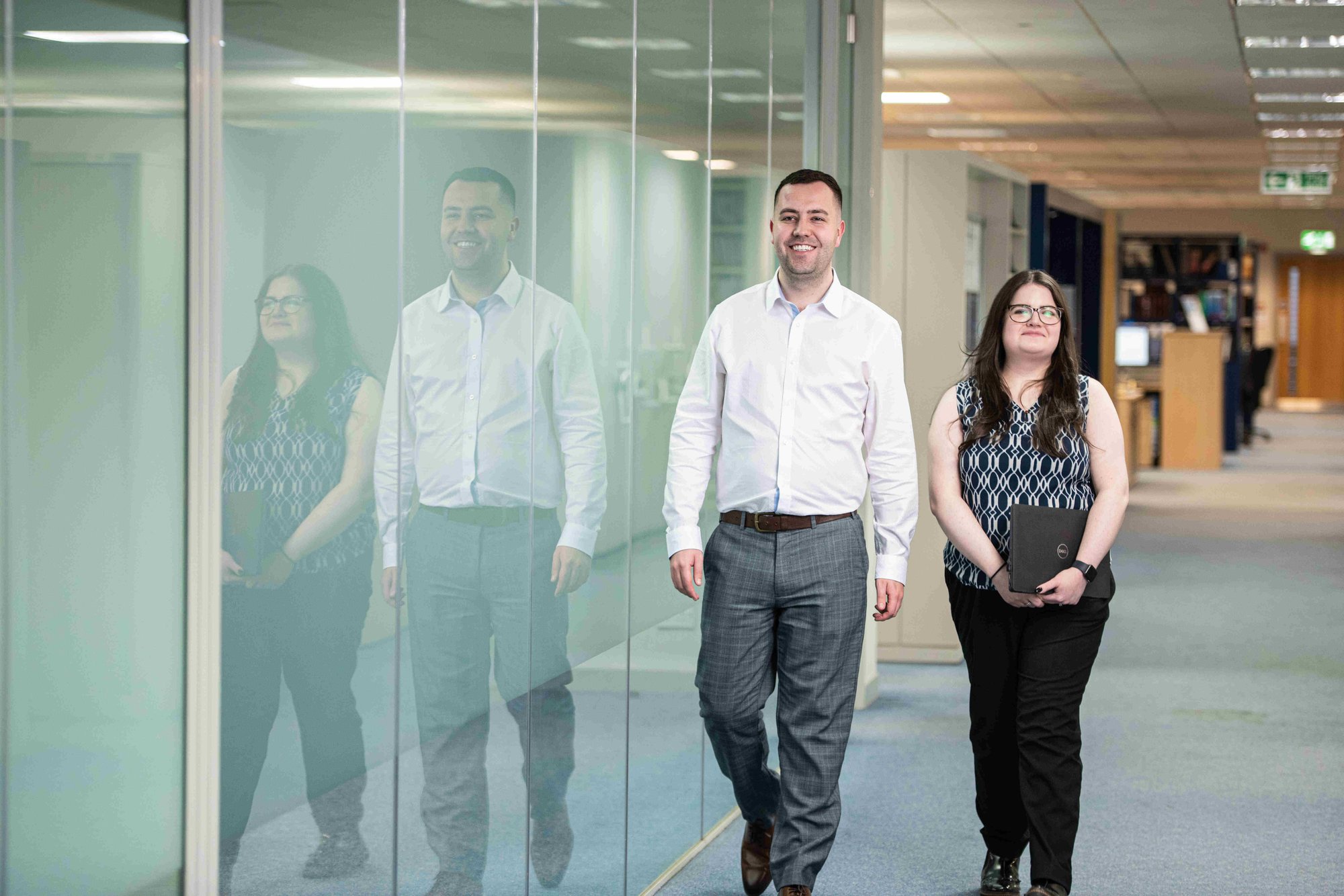 2 AAB employees walking through Glasgow office