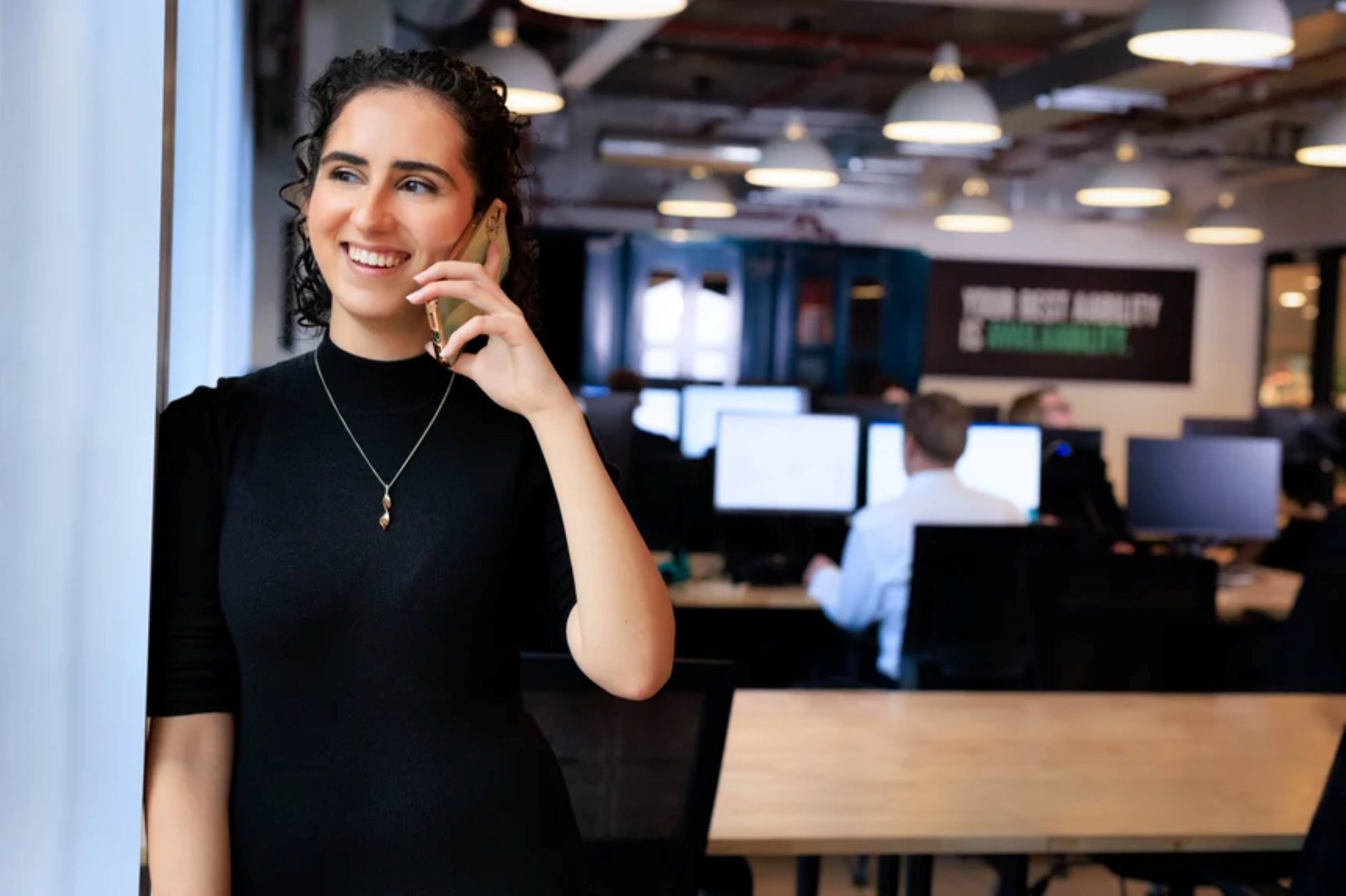 An image of an AAB employee in the office and on the phone. An image of an AAB employee in the office and on the phone.