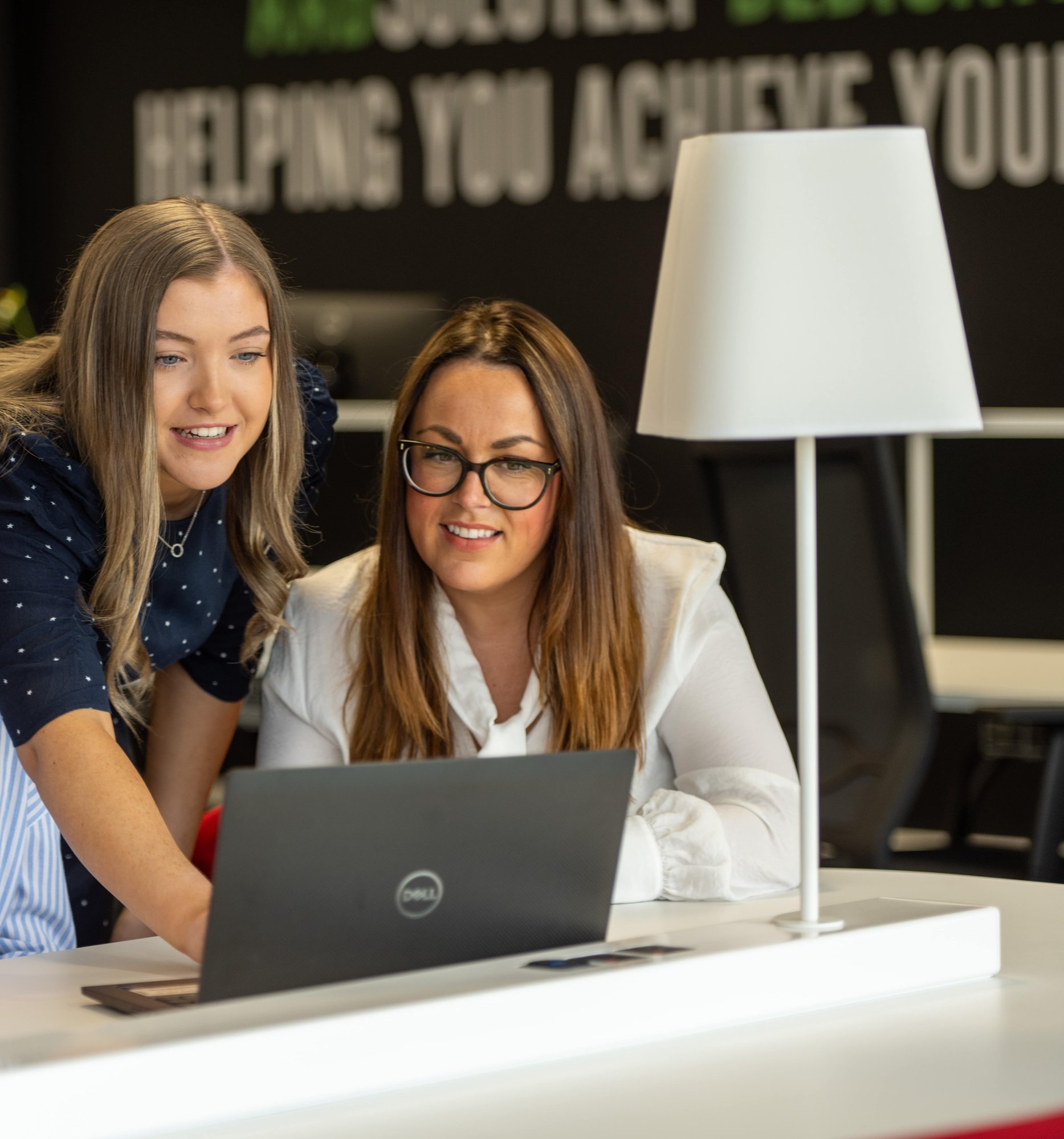 An image of two AAB employees reading information on a laptop. An image of two AAB employees reading information on a laptop.