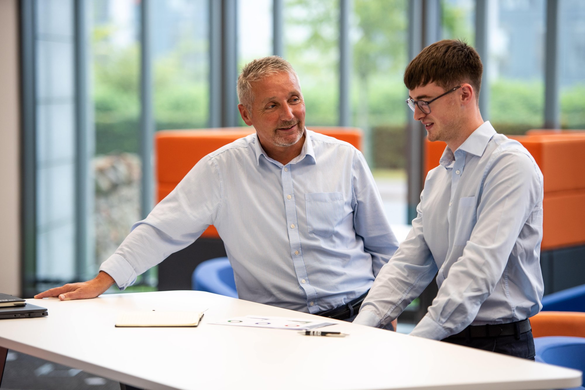 An image of two AAB employees in the Aberdeen office having a conversation.