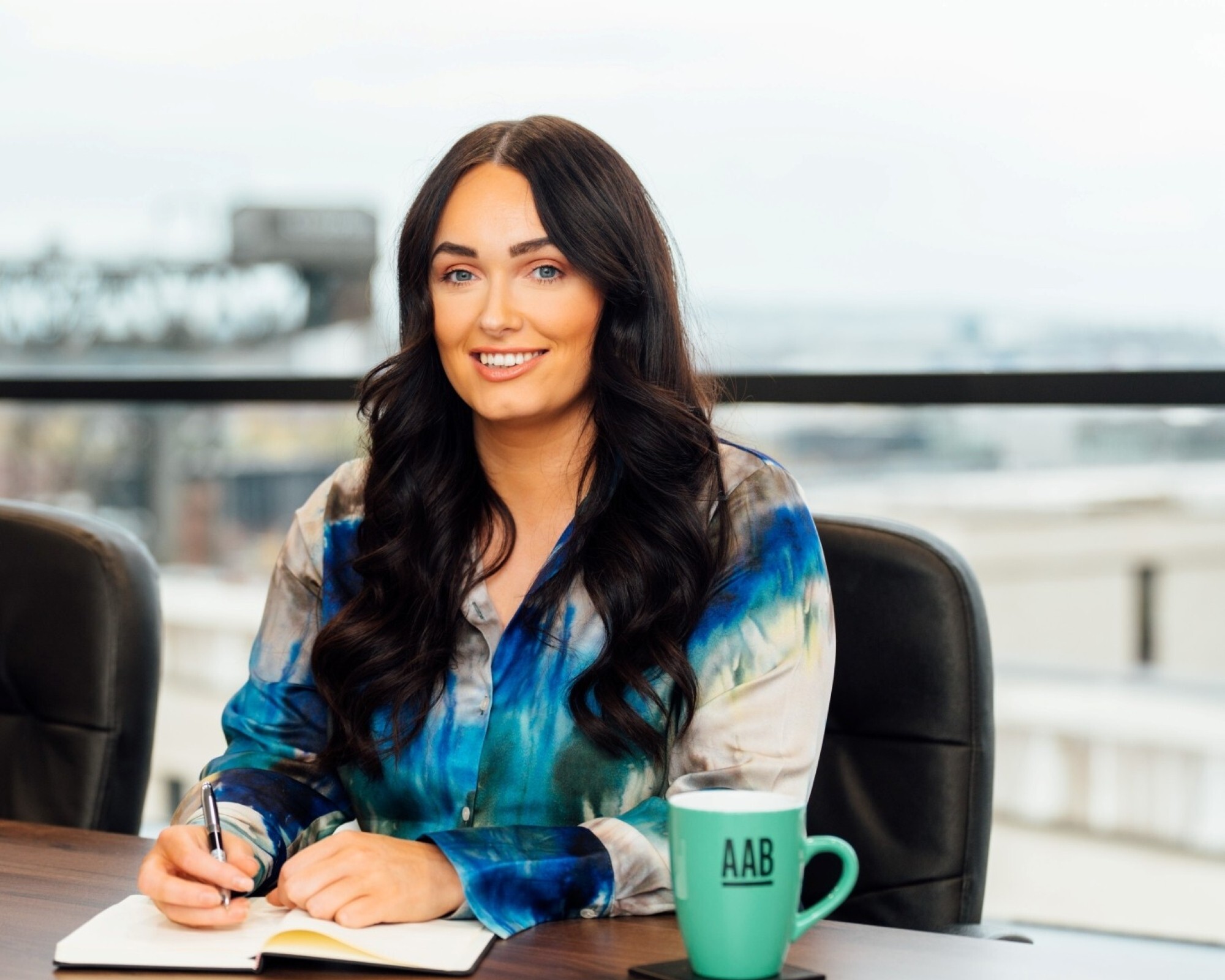 An image of Olivia Russell wearing a blue shirt and writing in her notebook. An image of Olivia Russell wearing a blue shirt and writing in her notebook.