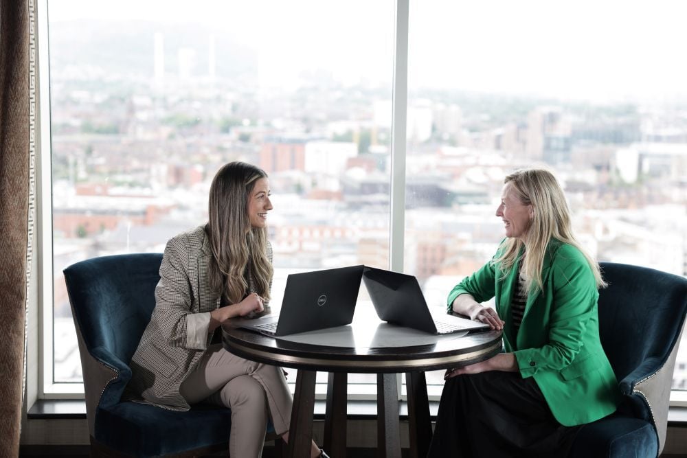 Two AAB employees at a meeting with scenic background